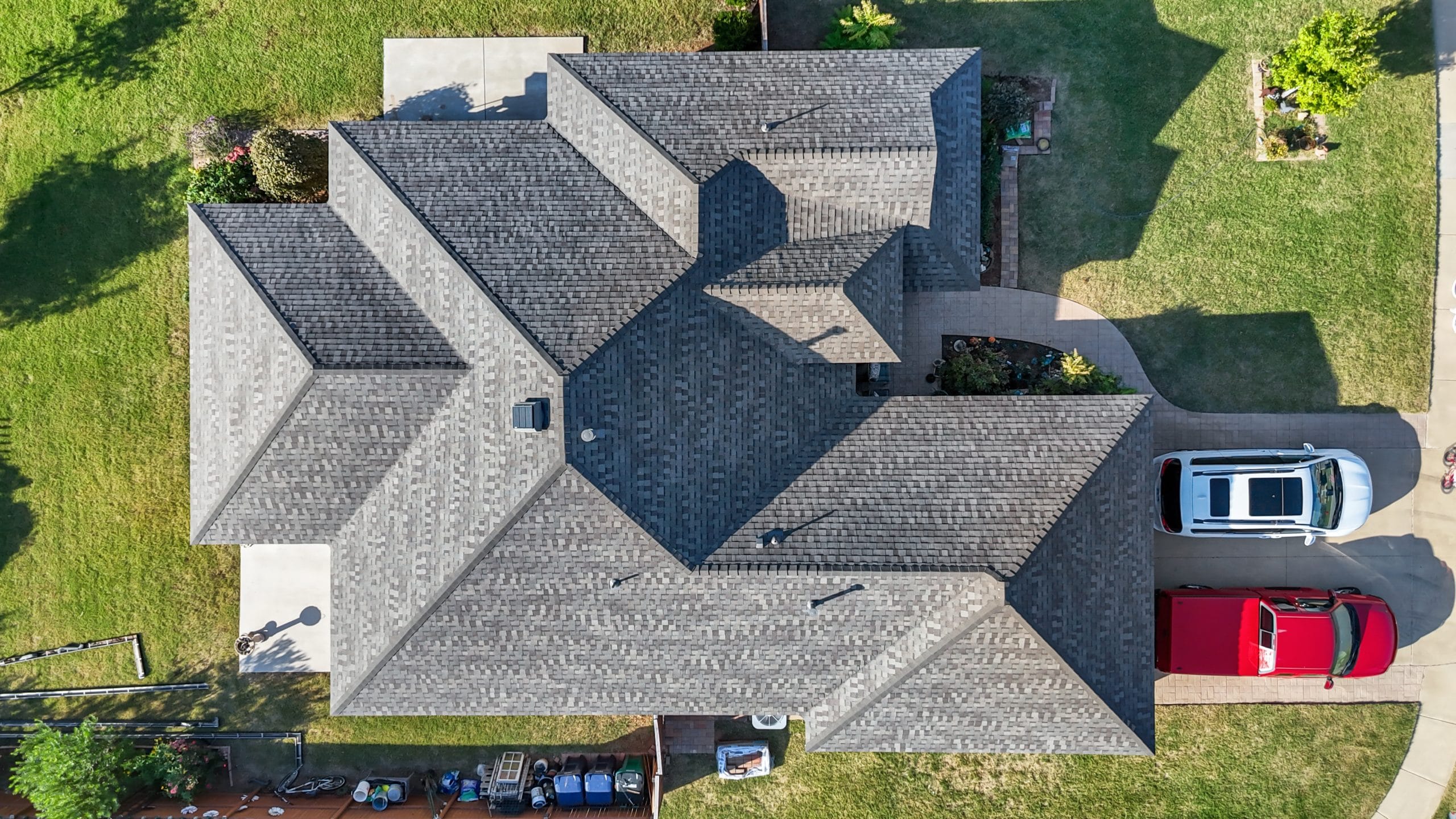 Weathered Wood Class 4 architectural shingle roof installation on a brick home in Edmond, Oklahoma.